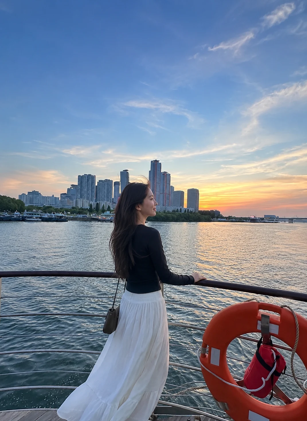 A guest watching the sunset from a Seoul Cruise deck